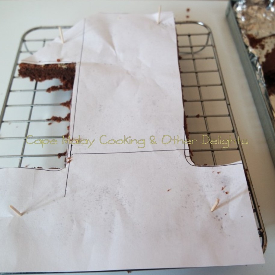 Place the number 1 shape in the centre of the cake, secure with toothpicks. Cut the cake around the number 1